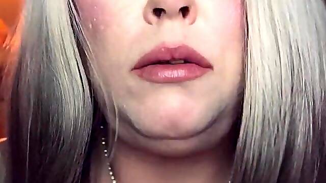 Big beautiful woman Golden-haired Tina Snua Smokes A Slender Cigarette In A Holder In Satin Gloves With Rings